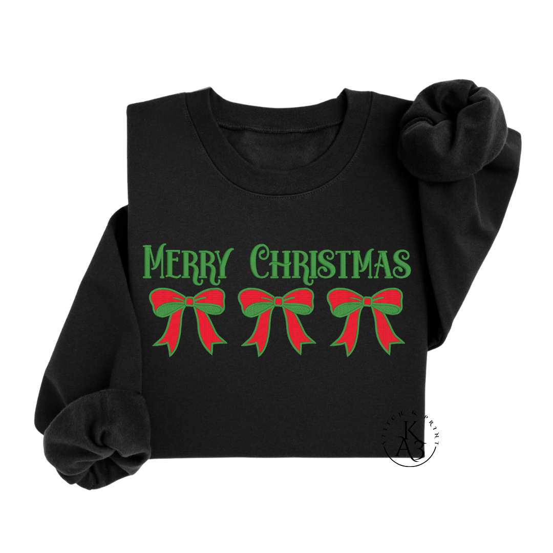 Black sweatshirt with en embroidered 'Merry Christmas' text and red and green bows on a white background