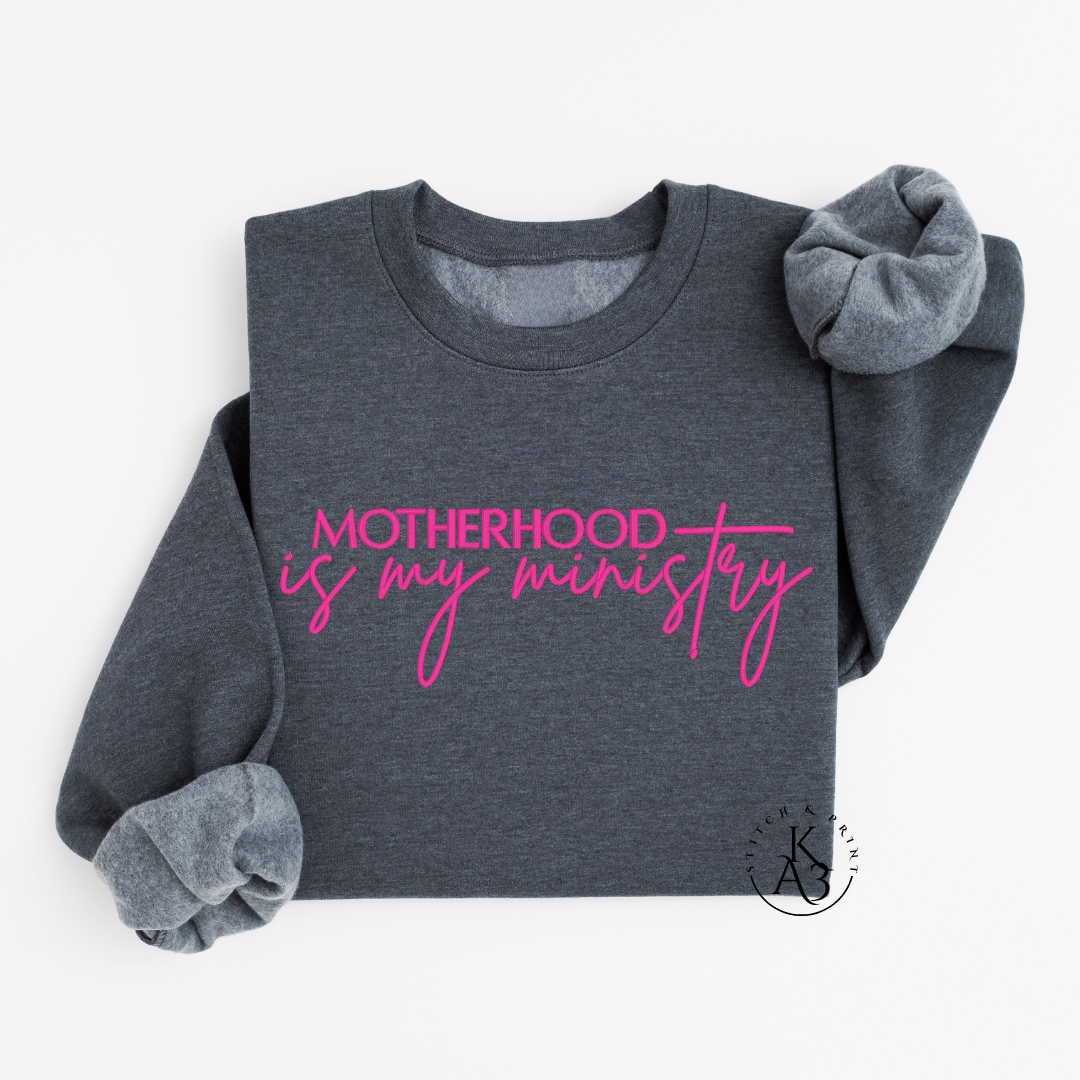 Personalized Dark Grey sweatshirt with pink text embroidered "Motherhood is my ministry"