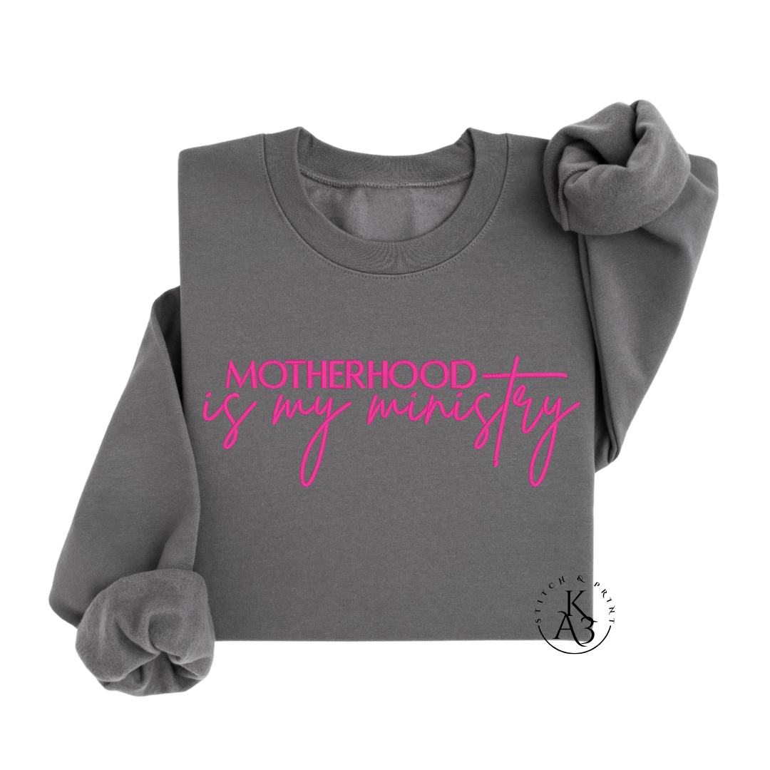 Personalized Charcoal sweatshirt with pink text embroidered "Motherhood is my ministry"