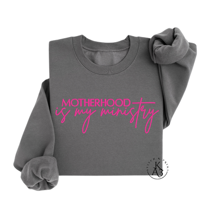 Personalized Charcoal sweatshirt with pink text embroidered "Motherhood is my ministry"