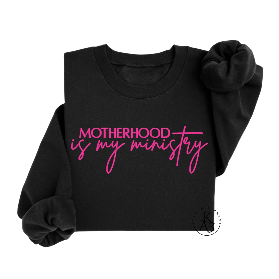 Personalized Black sweatshirt with pink text embroidered "Motherhood is my ministry"