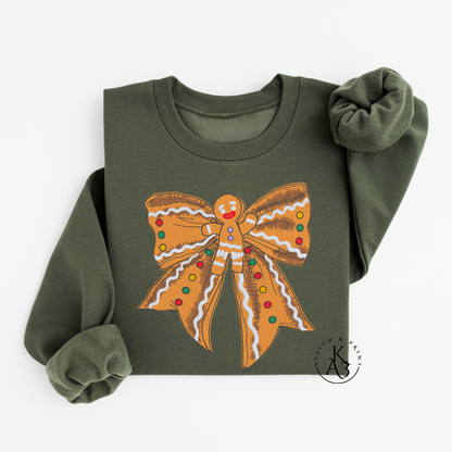 Green sweatshirt with an embroidered gingerbread bow design on a white background