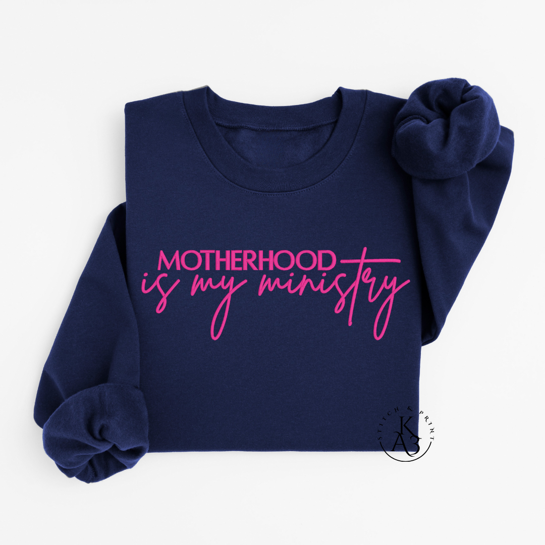 Personalized Navy sweatshirt with pink text embroidered "Motherhood is my ministry"
