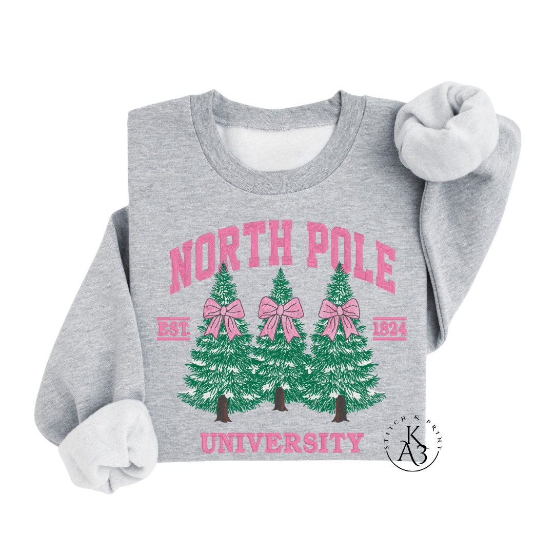 Gray sweatshirt with 'North Pole University' text and Christmas tree design on a white background
