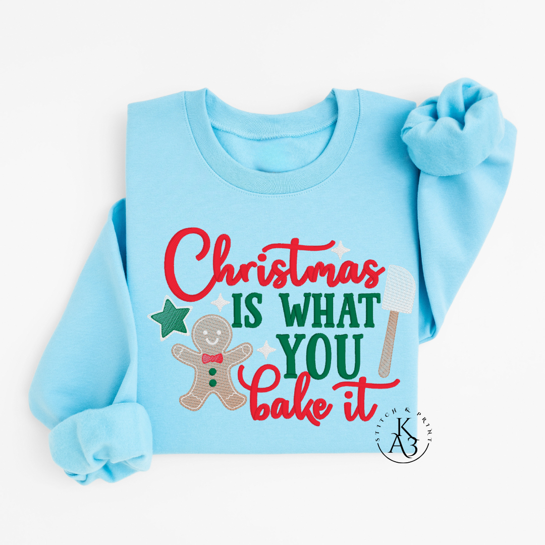 Light blue sweatshirt with Christmas-themed text and graphics on a white background