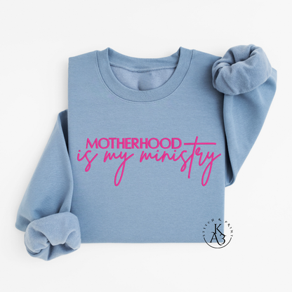 Personalized Stone Blue sweatshirt with pink text embroidered "Motherhood is my ministry"