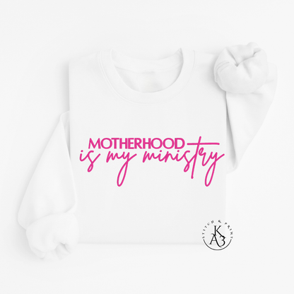 Personalized White sweatshirt with pink text embroidered "Motherhood is my ministry"