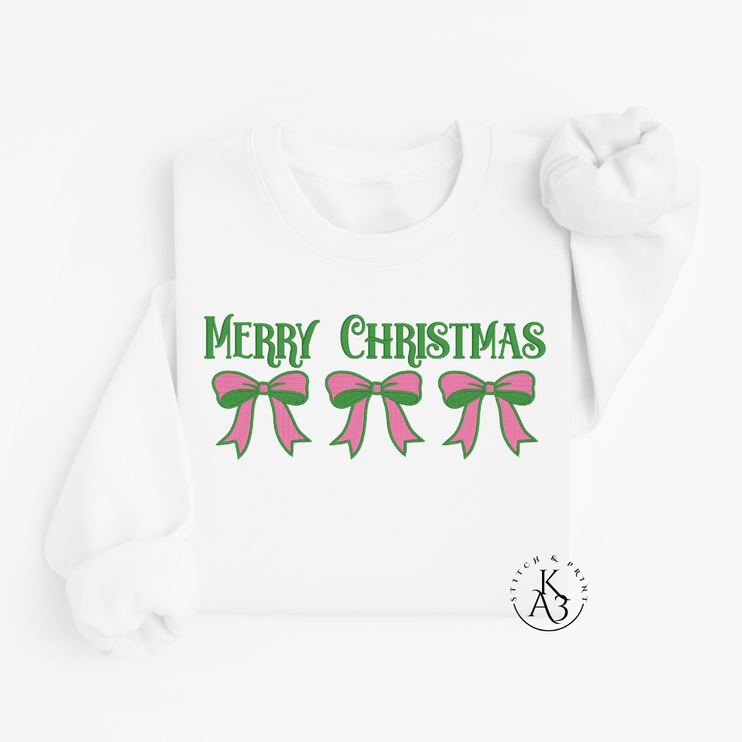 White Sweatshirt with an embroidered 'Merry Christmas' text with pink and green bows on a white background